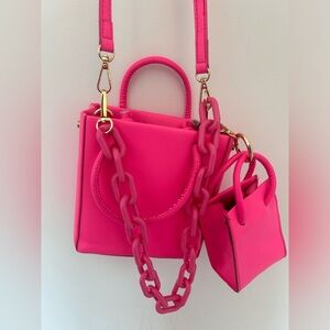 Neon pink crossbody bag with attached mini bag